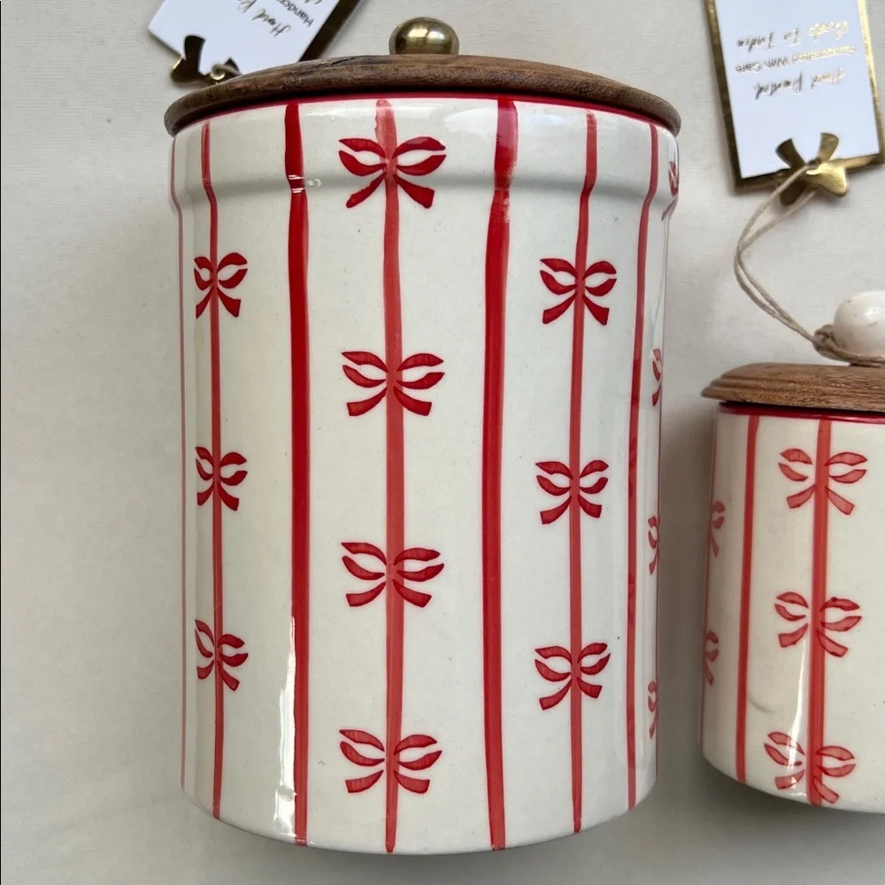 Ceramic holiday canister with red vertical stripes and bows